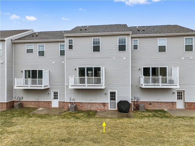 back of property featuring a patio, a lawn, and central AC