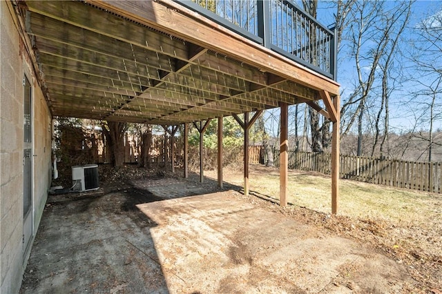 view of patio / terrace featuring a carport, central AC, and fence