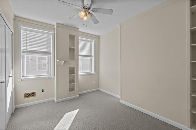 unfurnished bedroom featuring carpet flooring, a ceiling fan, baseboards, and a closet