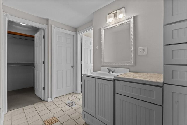 bathroom with a closet and vanity