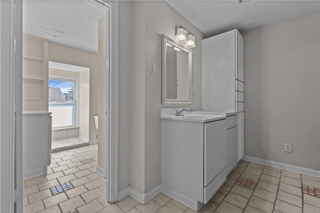 bathroom with baseboards and vanity