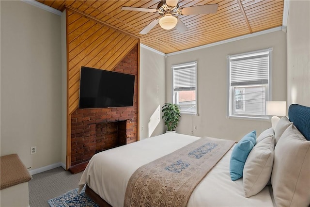 carpeted bedroom with ornamental molding, a ceiling fan, wooden ceiling, a fireplace, and baseboards