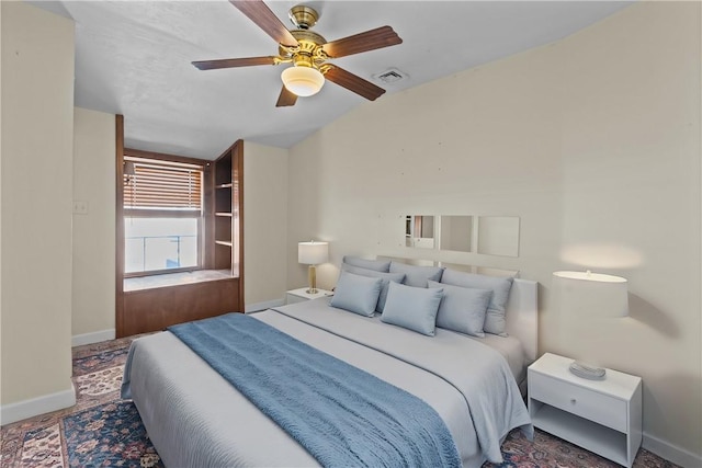 bedroom with visible vents, baseboards, a ceiling fan, and vaulted ceiling