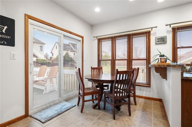 dining space with plenty of natural light, recessed lighting, baseboards, and light tile patterned floors