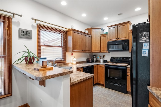 kitchen with recessed lighting, a peninsula, light tile patterned flooring, black appliances, and a sink