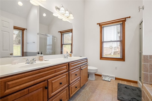 bathroom featuring a sink, visible vents, double vanity, and a shower stall