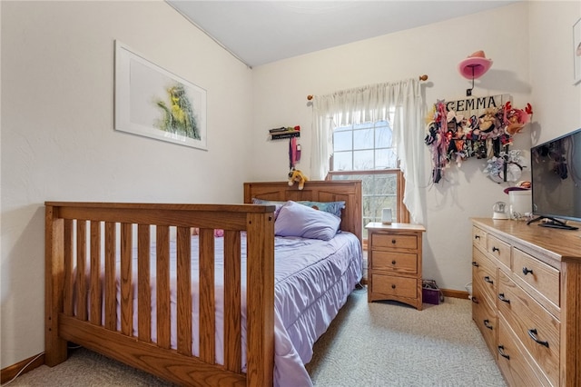 bedroom featuring carpet and baseboards