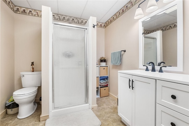 full bathroom with vanity, toilet, baseboards, and a stall shower