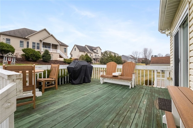 wooden deck featuring area for grilling and a residential view