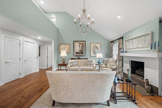 living area with recessed lighting, a brick fireplace, baseboards, and wood finished floors