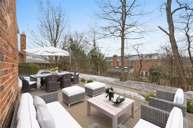 view of patio with an outdoor living space, outdoor dining area, and fence