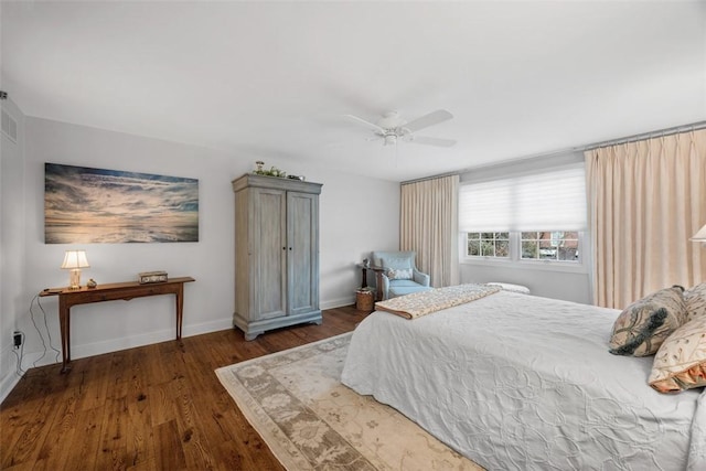 bedroom with ceiling fan, baseboards, and wood finished floors