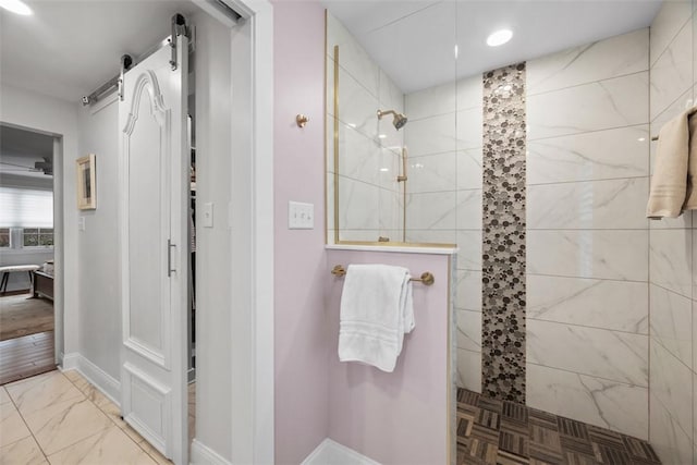 full bath featuring baseboards, marble finish floor, and walk in shower