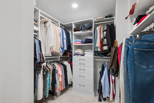 walk in closet with marble finish floor