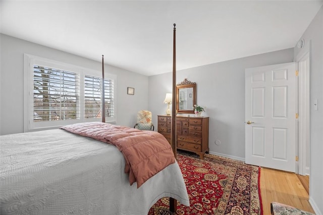 bedroom featuring wood finished floors and baseboards