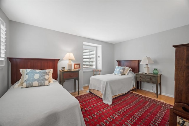 bedroom featuring wood finished floors and baseboards