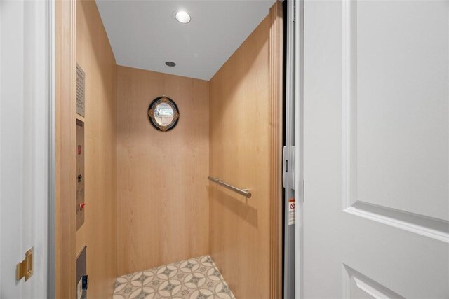 interior details with tile patterned floors and elevator