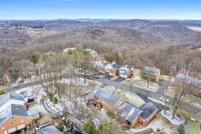 drone / aerial view featuring a residential view and a view of trees