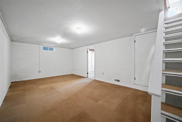 basement featuring tile patterned floors and visible vents