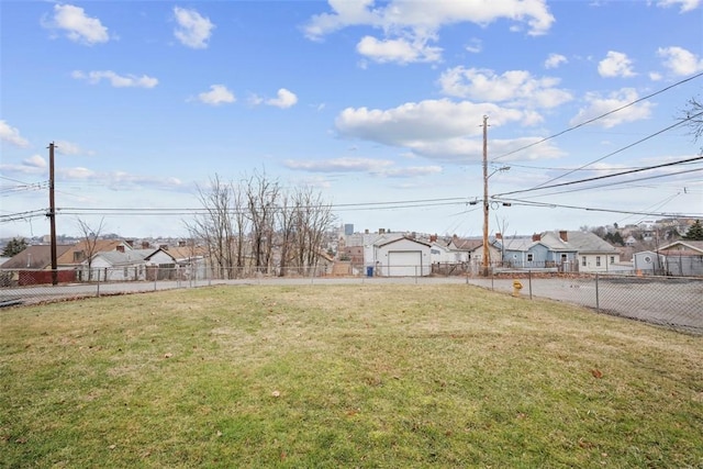 view of yard featuring fence and a residential view