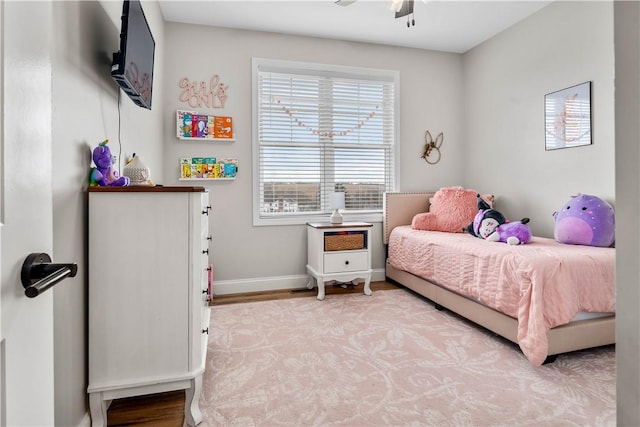 bedroom featuring baseboards and light wood finished floors