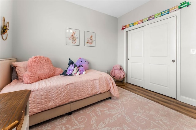 bedroom with a closet and wood finished floors