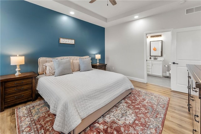 bedroom featuring visible vents, a sink, recessed lighting, light wood-style floors, and baseboards