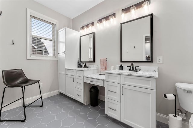 full bath featuring tile patterned floors, baseboards, toilet, and vanity