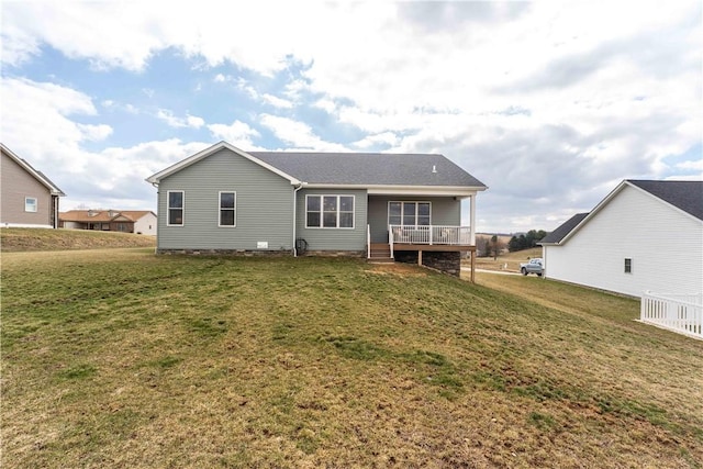 rear view of property with a porch and a lawn