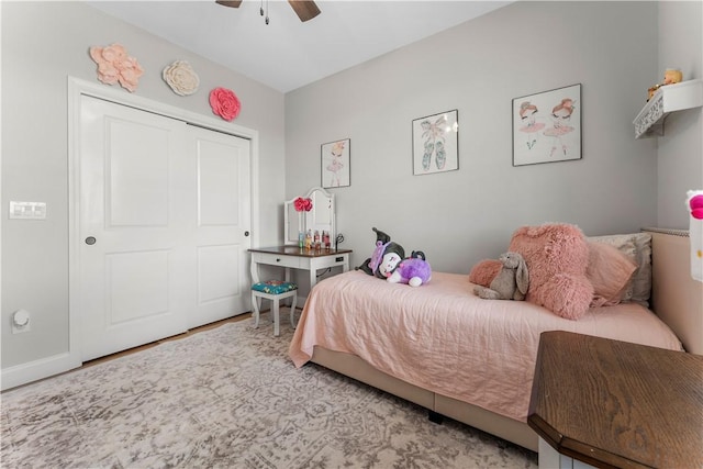 bedroom featuring a closet, wood finished floors, and ceiling fan