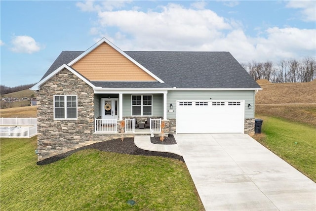 craftsman house with a porch, stone siding, a garage, and a front yard