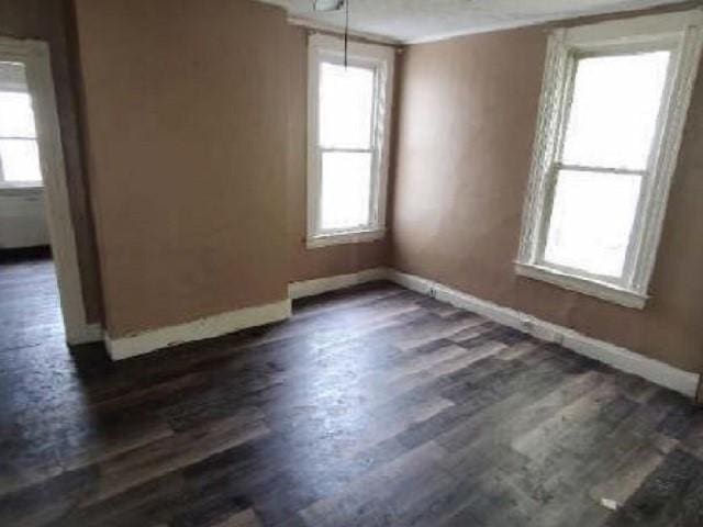 unfurnished room featuring dark wood finished floors and baseboards