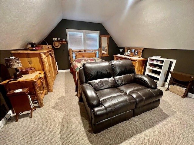 bedroom with light colored carpet, lofted ceiling, a textured ceiling, and baseboards