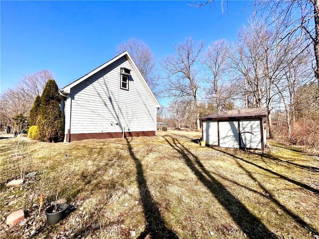 view of side of property with a storage shed and an outdoor structure