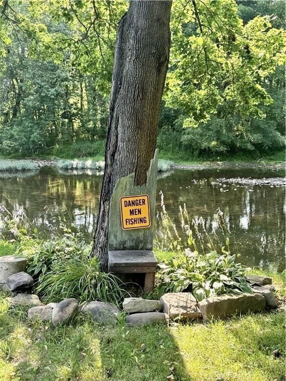 community sign featuring a water view