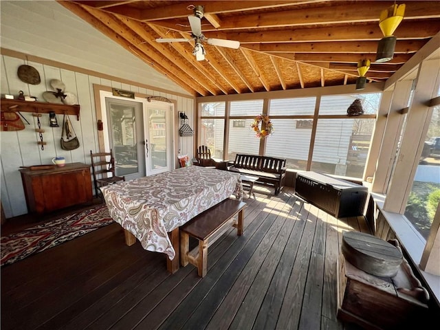 sunroom / solarium featuring lofted ceiling with beams and a ceiling fan