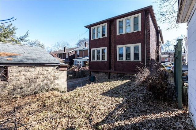 back of property featuring brick siding