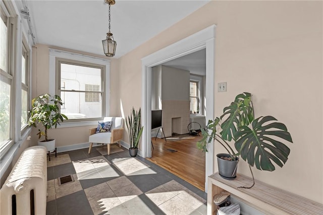 sunroom with radiator heating unit and visible vents