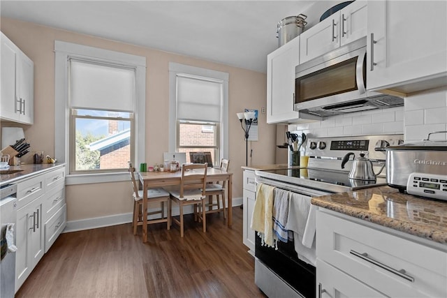 kitchen with decorative backsplash, appliances with stainless steel finishes, dark wood-style floors, and white cabinetry