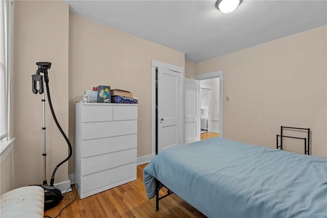 bedroom with baseboards and wood finished floors