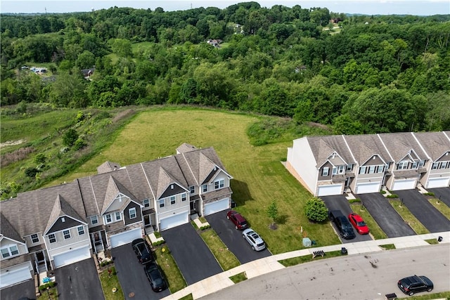 drone / aerial view with a residential view and a wooded view