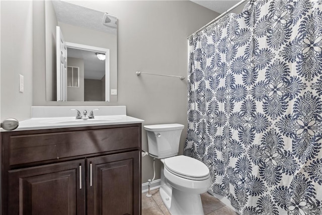 bathroom featuring toilet, vanity, a shower with curtain, tile patterned floors, and a textured ceiling