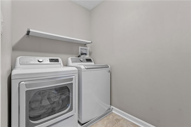 laundry area featuring washer and dryer, laundry area, and baseboards