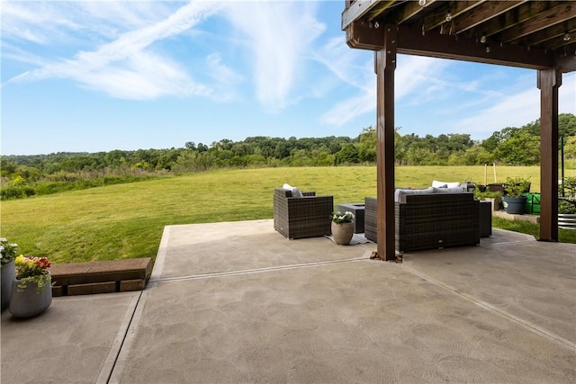 view of patio / terrace with an outdoor living space and a forest view