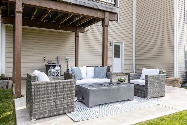 view of patio / terrace with an outdoor living space with a fire pit