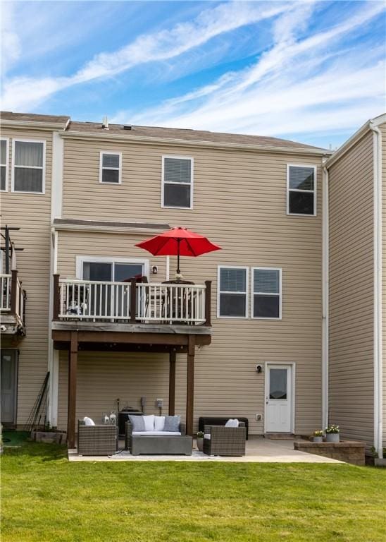 rear view of house featuring a patio area, an outdoor living space, and a yard