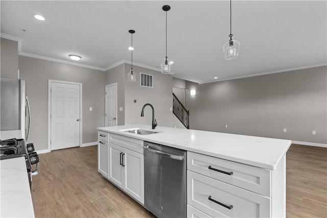 kitchen with light wood finished floors, a sink, fridge, and stainless steel dishwasher