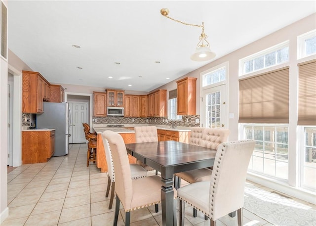 dining space with light tile patterned floors, visible vents, and recessed lighting