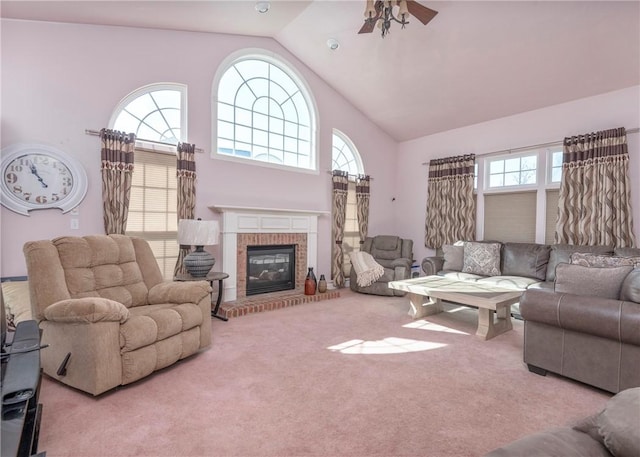 living room with ceiling fan, carpet flooring, a fireplace, and high vaulted ceiling