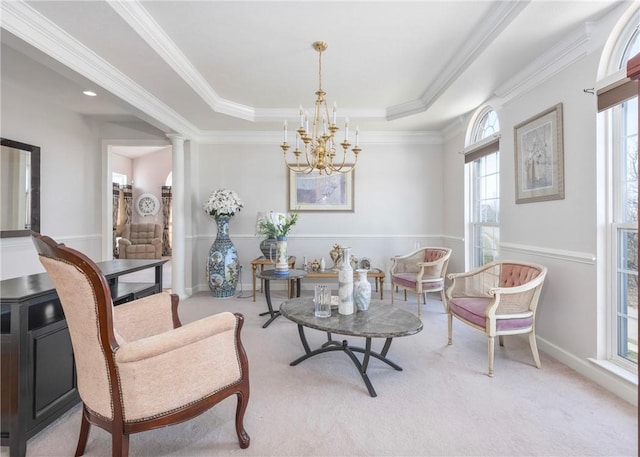 living area featuring carpet, crown molding, a tray ceiling, and decorative columns